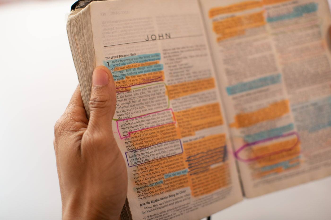 An open Bible at the Gospel of John, with highlighted verses
