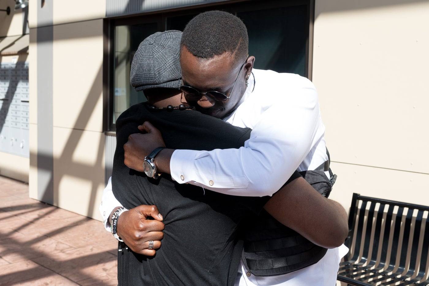 Two young men embracing