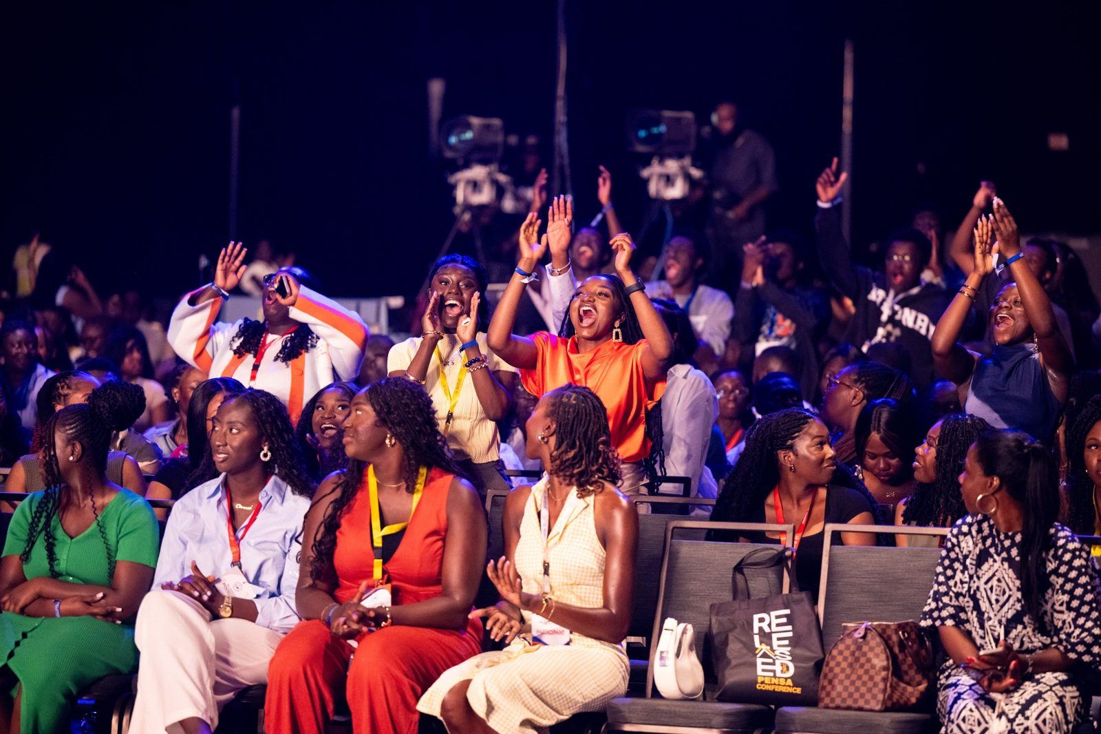 Young people cheering in worship at a PENSA conference